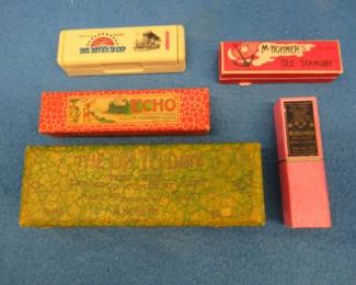 Lot 165. Five empty harmonica boxes: Hohner 7-inch The Up To Date tremolo harmonica box with metal hinges in VGC. Hohner The ECHO 5 3/4" box. Hohner Old Standby No. 34B. Hohner Big River Harp plastic box. Hohner 4 1/8" two-piece box.