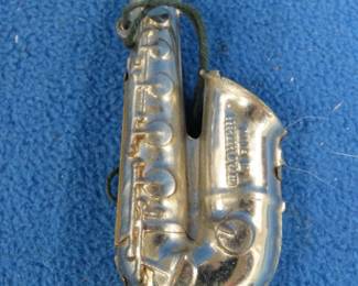 Lot 235. Toy tin 5-hole 4-inch saxophone harmonica. Sounds great.