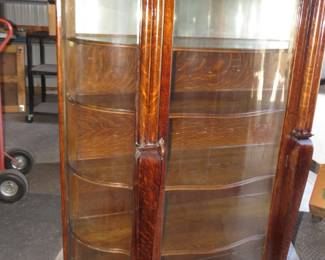 Lot 119. Ornate antique cabinet with rare recurved glass panels. 66 x 45 x 17 inches. Minimum bid $250.