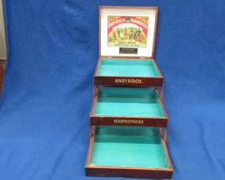 Lot 90. Vintage Ands Koch's World Renowned Harmonicas wooden stackable hinged tray box for harmonicas with clean, bright graphics and in excellent condition. Minimum bid $50