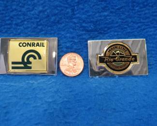 Lot 213. Two sterling silver ingots from "The Great American Railroad Emblems" series. Conrail and the Denver & Rio Grande Western. Total weight of 46.6 grams.