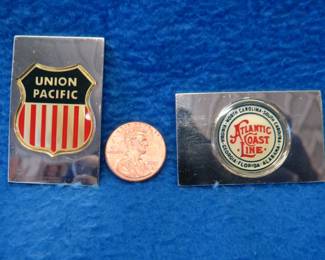 Lot 214. Two sterling silver ingots from "The Great American Railroad Emblems" series. The Union Pacific and the Atlantic Coastline. Total weight of 46.0 grams.