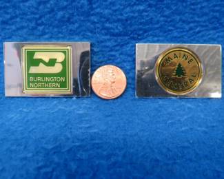Lot 212. Two sterling silver ingots from "The Great American Railroad Emblems" series. The Burlington Northern and the Maine Central. Total weight of 46.0 grams.