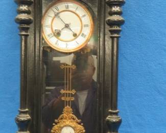 Lot 134. Vintage wall mount pendulum clock. Including finials approx. 37". Untested.