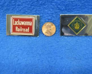 Lot 219. Two sterling silver ingots from "The Great American Railroad Emblems" series. The Lackawanna and the Baltimore & Ohio. Total weight of 46.7 grams.
