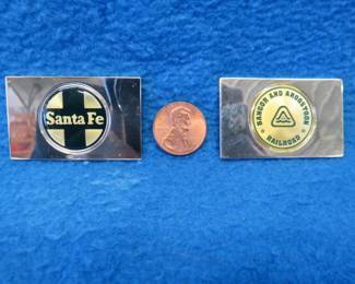 Lot 211. Two sterling silver ingots from "The Great American Railroad Emblems" series. The Santa Fe and the Bangor and Aroostook. Total weight of 46.9 grams.