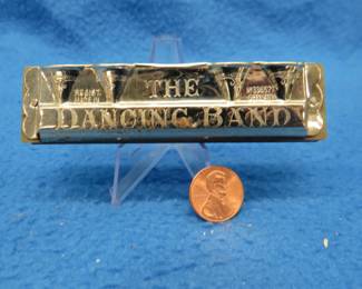Lot 163. Unknown German maker Dancing Band diatonic 12-hole fluted harmonica and two-piece box in fair condition.