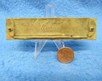 Lot 97. Very old pioneer era Gebruder Ludwig harmonica made circa 1844 with the Richter blow and draw mechanism. Does not sound.
