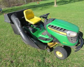 Lot 26. John Deere D130 riding mower with bagger system, JD 22-HP engine with 495.6 hours, and 42-inch cutting deck. Seller states that a front tire has slow leak and battery, blades, and belt were replaced last season. Starts and runs.