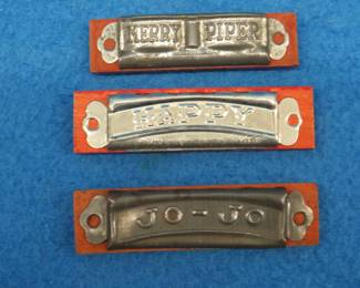 Lot 98. Three vintage miniature harmonicas: Unknown maker 3 1/4" 6-hole "Happy" harmonica. Poor sound. Unknown maker 3 1/4" 6-hole "Jo-Jo" harmonica. Blow sound only. Unknow