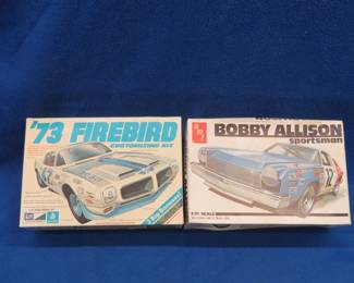 Lot 70. Two model cars: General Mills 73' Firebird, has been opened please inspect. AMT Bobby Allison Sportsman racecar, still in packaging.