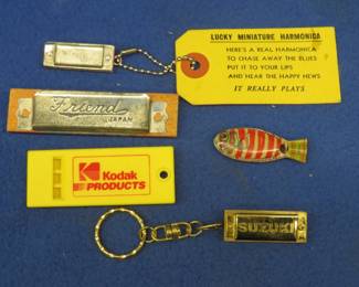 Lot 43. Five novelty or advertising miniature harmonicas