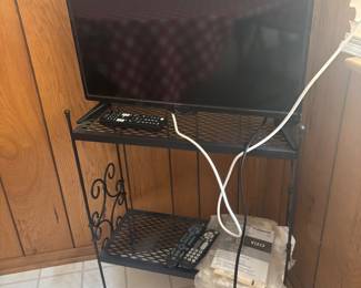 cute wrought iron stand and flat screen tv