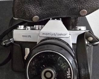 Introduced around 1968 - Mamiya/Sekor 500 DTL 35mm SLR film cameral with a 50mm lens and leather case.