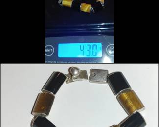 Mexican Taxco sterling silver link bracelet featuring alternating cylindrical panels of black onyx and tiger's eye gemstone