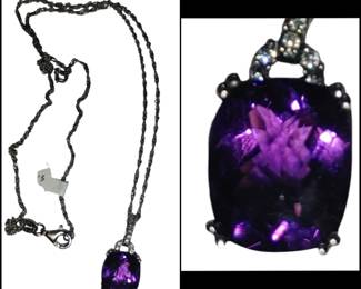 sterling silver pendant featuring a large, cushion-cut purple amethyst gemstone.