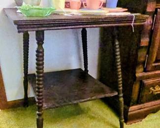 Victorian-era solid oak side table featuring distinct barley twist legs and a lower display shelf