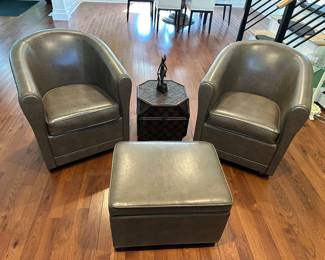 Pair of leather barrel-back chairs and storage ottoman; chairs 32" t with 19" seat opening; ottoman 24" w x 18" x 17" t; $450