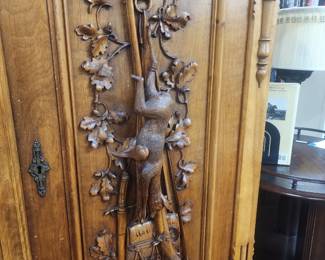 Carved gun cabinet
