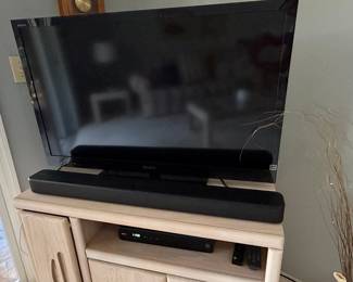 Sony BRAVIA Flat Screen TV, Sony Soundbar, and Xfinity Box on Entertainment Console