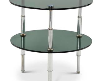 322 A Modern smoky glass and chrome tiered side table Circa 1980s Unmarked The two circular glass tiers raised on chromed metal tubular supports 22.75" H x 22.125" Dia. Estimate: $200 - $400