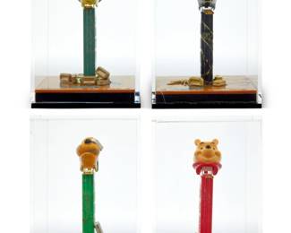 379 Pinkhas (b. 1975) Four works from the series "Combien Tu Pez?" Painted plastic Pez dispensers and gold bars, in acrylic cases Each signed: Pinkha$; each bar numbered and marked: 1g / FINE GOLD / 999.9 Representing the characters Winnie The Pooh, Spiderman, Fiona, and Pluto 4 pieces Each case: 6.25" H x 4.25" W x 4.25" D Estimate: $400 - $600