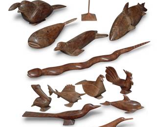 108 A large group of carved wood animals 20th century Each unmarked Comprising a whale, shark, seal, pelican, dolphin, snake, swordfish, rooster, bird, two quail, and a seabird raised on a base 12 pieces Larger quail: 7.75" H x 20" W x 5.25" D; Snake: 28" L; Pelican: 7" H x 7" W x 3.5" D Estimate: $200 - $400