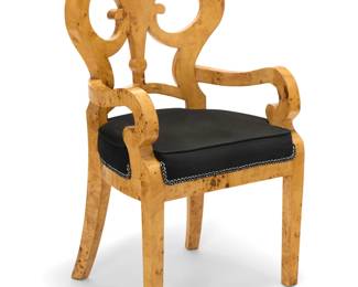 15 A Biedermeier style burl maple chair Late 20th century With open scrollwork back and curved armrests above a seat cushion upholstered in a black cotton fabric with passementerie trim 41.25" H x 24" W x 22" D Estimate: $300 - $500