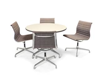173 Charles and Ray Eames (1907-1978 and 1912-1988) A segmented round table and four Aluminum Group side chairs for Herman Miller, circa 1990s Each chair base numbered in the mold: 938-138; and with applied factory label; table unmarked Each piece raised on four aluminum legs and enameled steel standard, the table with vinyl veneered wood top, the chairs with grey fabric upholstered swivel seats 5 pieces Table: 28.5" H x 42.25" Dia.; Each chair: 33" H x 28.5" W x 28.5" D Estimate: $1,000 - $2,000
