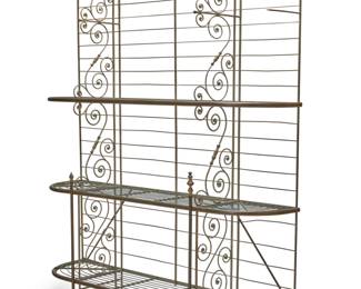 21 A French baker's rack Early 20th century Brass and metal alloy, with laddered back and three tiers of removable wire shelving between two scroll supports 94.75" H x 79.25" W x 20" D Estimate: $600 - $800