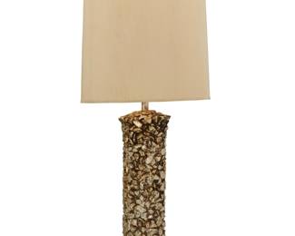320 A Modern silvered ceramic table lamp Late 20th century Unmarked The cylindrical base in the form of stacked stones, issuing a single light, surmounted by a cylindrical fabric shade with passementerie trim, electrified Lamp base with harp: 34.75" H x 7.25" Dia.; Shade: 18.25" H x 16.75" Dia. Estimate: $200 - $400