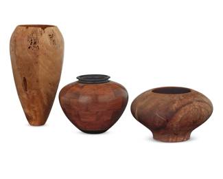 105 Three turned wood vessels Late 20th/early 21st century Two signed: Jim McLain; one dated: 9/2003; one inscribed: BUBINGA / EBONY; the last incised: Glenn Williams / Camphor Comprising a bubinga and ebony wood olla-form jar and a burlwood vase, each by Jim McLain (20th Century), and a carved camphor vessel by Glenn Williams (20th Century) 3 pieces Vase: 7" H x 3.75" Dia.; Lowest vessel: 3.125" H x 5.25" Dia. Estimate: $500 - $700