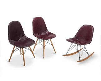 362 Charles and Ray Eames (1907-1978 and 1912-1988) An Eiffel Tower rocker and two shell side chairs, late 20th century Each unmarked Each burgundy Naugahyde over fiberglass shell on enameled wire frame 3 pieces Rocker: 28" H x 28" W x 19" D; Each side chair: 33.75" H x 19" W x 20" D Estimate: $500 - $700
