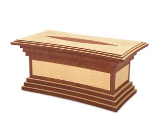294 A Postmodern exotic wood coffee table Late 20th/early 21st century Unmarked With tiered top and base 16.75" H x 36.125" W x 19.75" D Estimate: $700 - $900