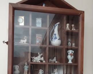 Wall curio full of unique miniatures