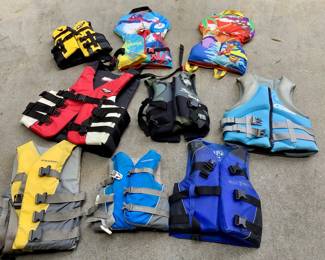 Various adult and child life vests.