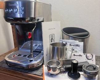 Breville Bambino Plus Espresso Maker.  Very good quality and well-maintained.  Includes all original accessories as well as a Breville brand knock box and extra official descaling and cleaning packets.