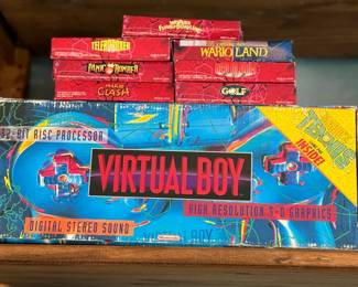 Nintendo Virtual Boy Console + AC Adapter and 8 games. Console and 7 games in original boxes. Broken Stand. 