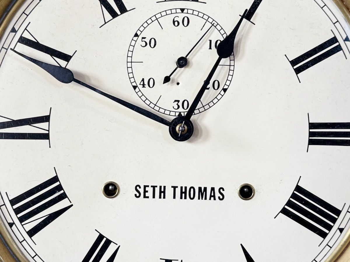 This lot features a Seth Thomas “World” model long-drop schoolhouse clock from the late 19th century.  It features a distinctive octagonal top and a long lower case for the pendulum. Tested and in good working condition with key. Measures, 32” H x 17” W.
