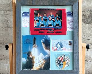 This lot features a curated collection of space memorabilia held and displayed in a wooden frame. Includes an autograph from Christa McAuliffe and much more. This piece measures in frame, 22.5” H x 18.75” W.