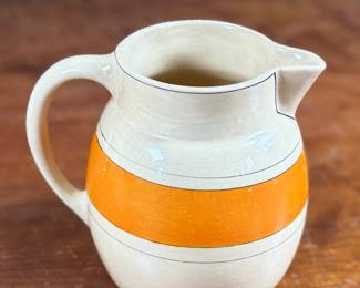 This lot features an early banded pitcher by Roseville Pottery circa 1920s or 1930s. The pitcher is in good condition and measures, 6.25” H x 7.5” W x 5.5” D.