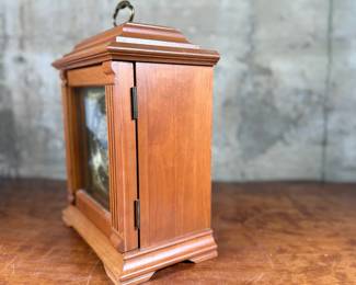 This lot features an Emperor Mantel Clock in good working condition with a key. This clock measures, 15” H x 11” W x 6” D. Franz Hermle two (2) jewel movement.