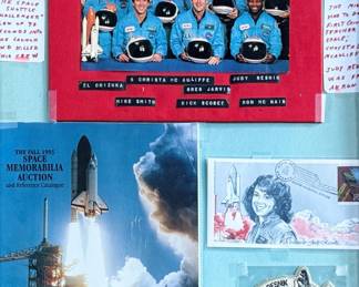 This lot features a curated collection of space memorabilia held and displayed in a wooden frame. Includes an autograph from Christa McAuliffe and much more. This piece measures in frame, 22.5” H x 18.75” W.