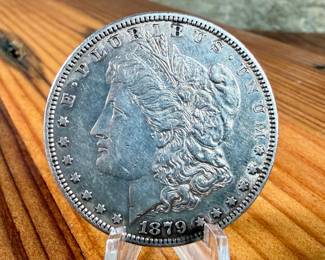 This lot features a 1879 Morgan Dollar.