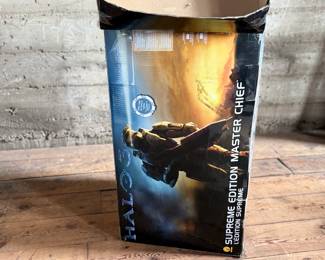 Halo Supreme Edition Master Chief costume, featuring detailed armor components and bodysuit. Includes helmet, chest piece, and other parts. Comes in its original packaging, which shows signs of wear, including creases and tears. Appears to be used and is sold as is. Ideal for collectors or cosplay enthusiasts.
