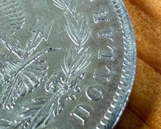 This lot features a 1878-CC Morgan Dollar.