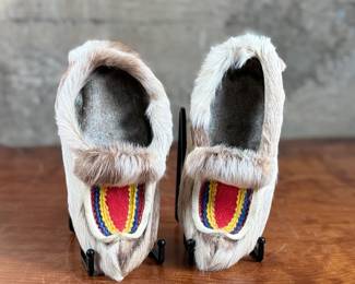 These reindeer fur slippers feature traditional Sami-style colorful decorative detailing on the front and measure, 9” heel to toe.