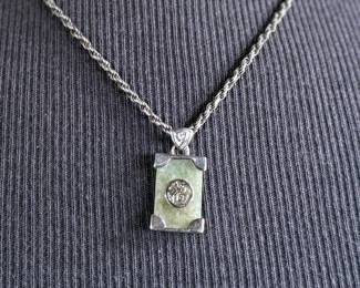 This lot features a stunning sterling silver necklace with a silver pendant wrapped around a jade stone. Measures, 20” and has a total approx. weight of 12.80 grams.