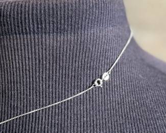 This lot features a sterling silver necklace with a “Kokopelli” pendant. Measures, 18”. 