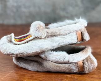 These reindeer fur slippers feature traditional Sami-style colorful decorative detailing on the front and measure, 9” heel to toe.